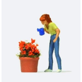 Woman watering a flower pot